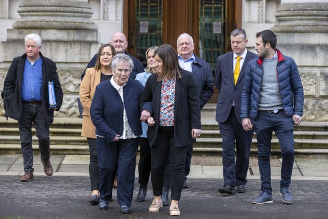 Bridie Brown, (front left) the widow of murdered GAA official Sean Brown, with family members and legal team outside Belfast High Court (Liam McBurney/PA)