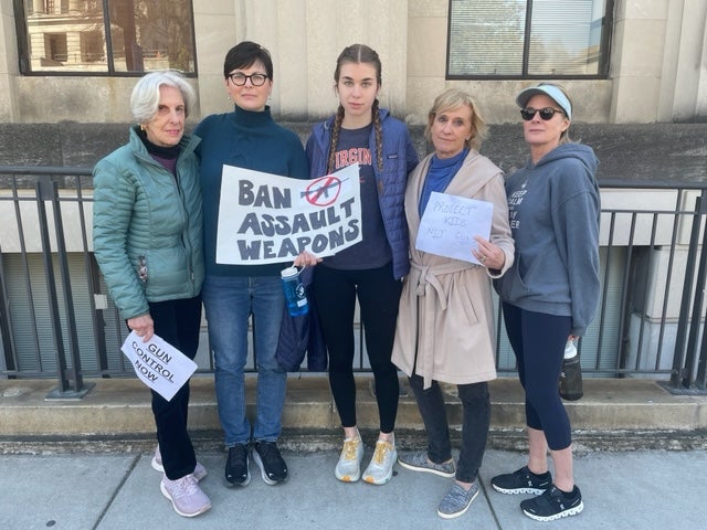 Linda Herrell, 45, holds a ‘BAN ASSAULT WEAPONS’ sign as she stands next to her 17-year-old daughter, Eleanor, and friends after a Thursday rally at the Tennessee State Capitol