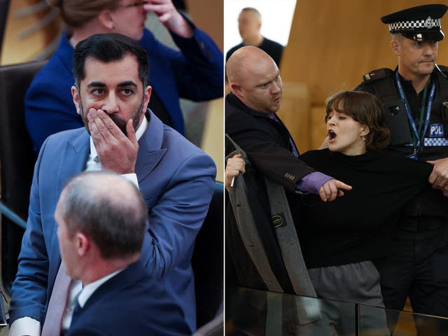 <p>The first minister watches as a protester is removed from parliament </p>