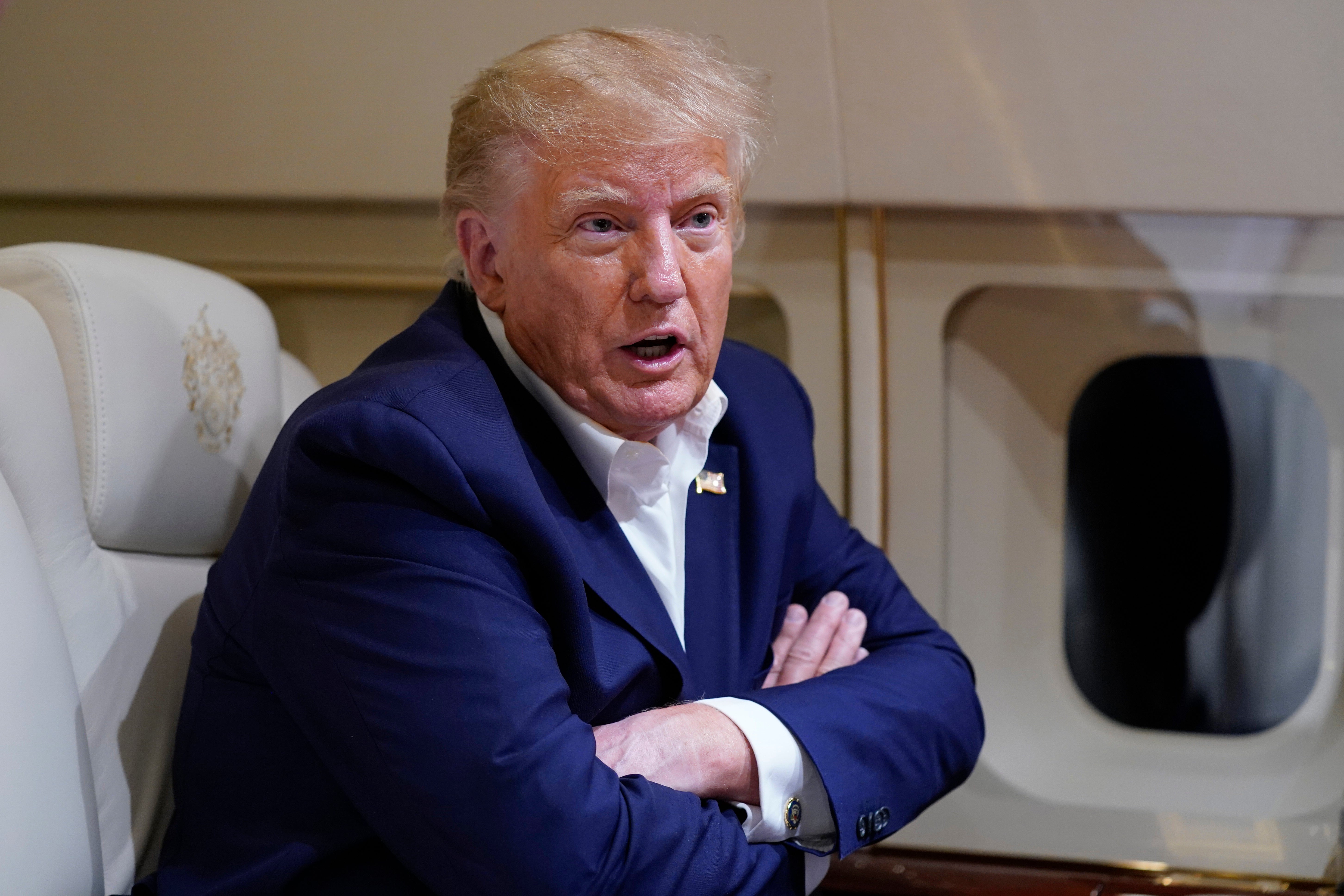 Former President Donald Trump speaks with reporters while in flight on his plane after a campaign rally at Waco last week