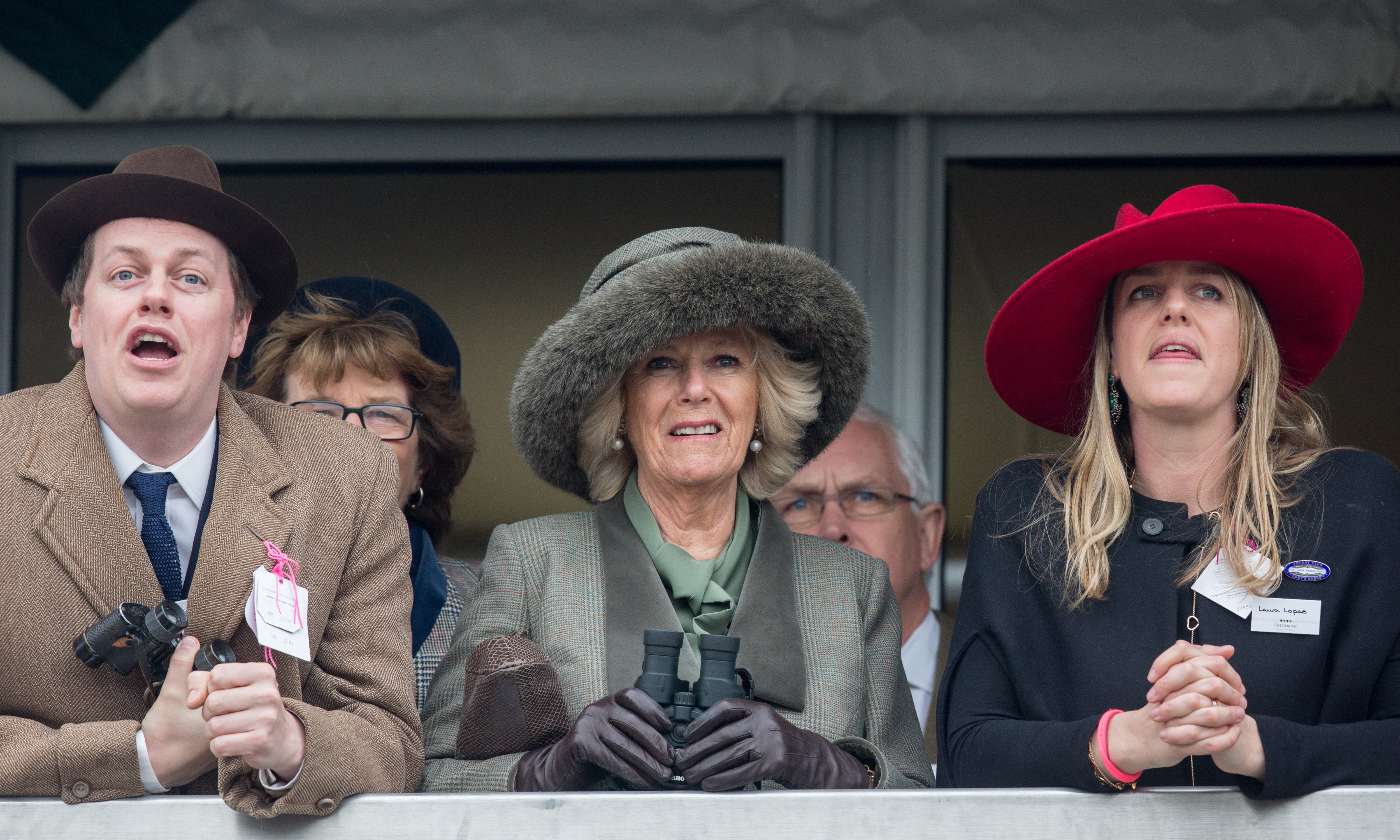 Camilla, Duchess of Cornwall (C) watches a race from the temporary Royal Box with her son Tom Parker Bowles and daughter Laura Lopes