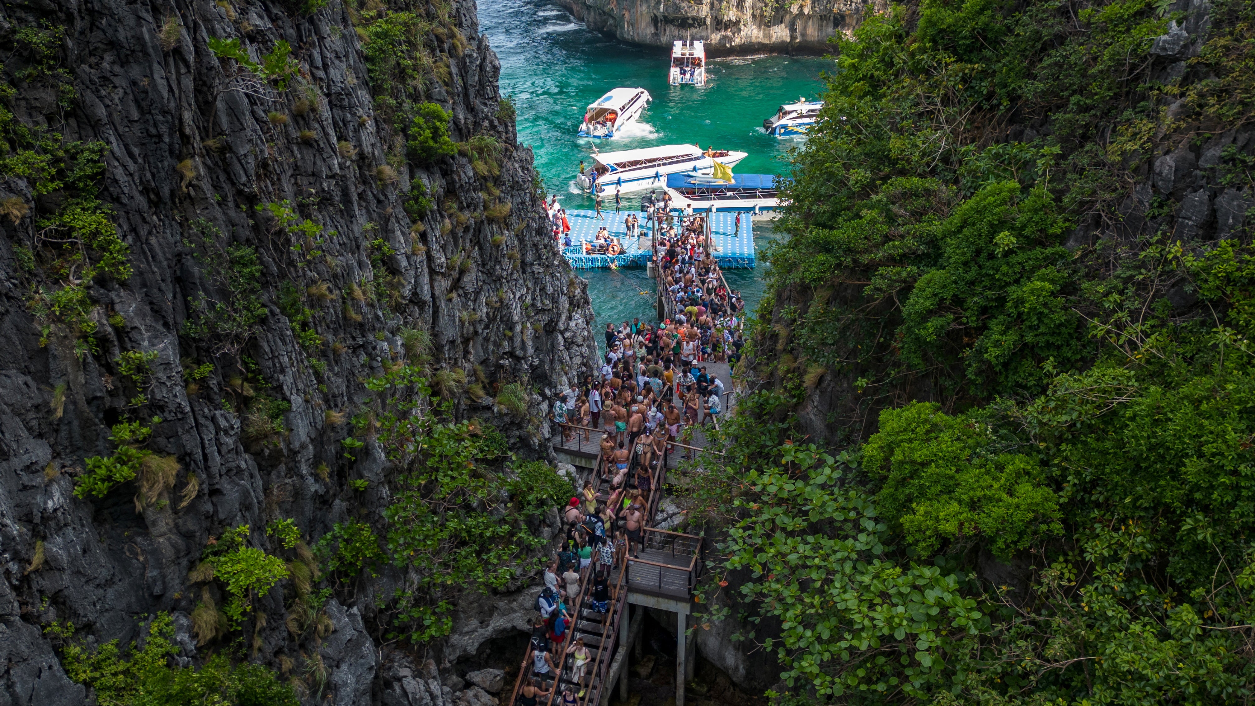 Tourists arrive for an hour-long visit to Maya Bay beach through a new pier constructed over a reef in Loh Samah Bay beach