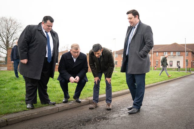 <p>‘A plague on our roads’: Rishi Sunak inspects a pothole in Darlington, County Durham</p>