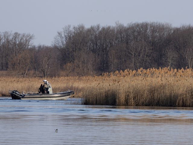 <p>Police search the marshland where bodies were found in Akwesasne, Quebec, Canada March 31, 2023.  REUTERS/Christinne Muschi</p>