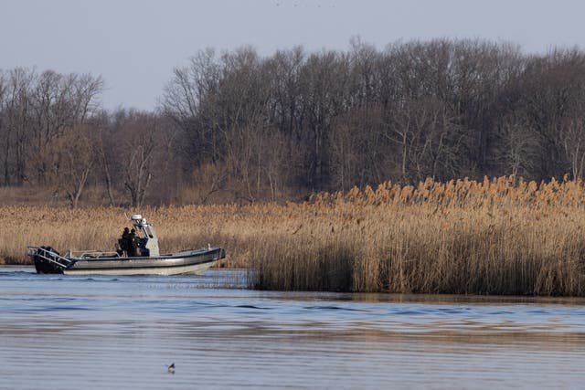 <p>Police search the marshland where bodies were found in Akwesasne, Quebec, Canada March 31, 2023.  REUTERS/Christinne Muschi</p>