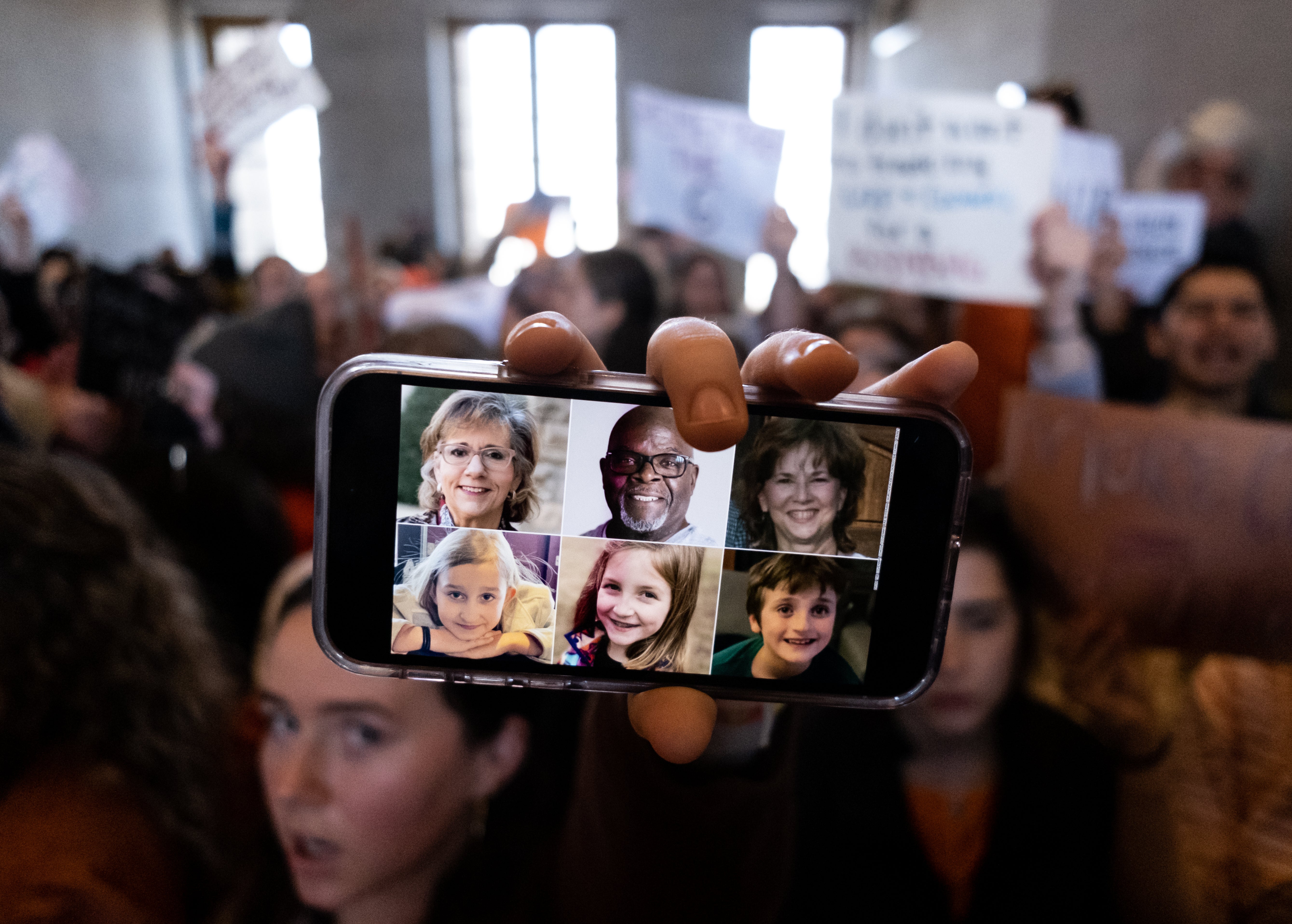 A demonstrator displays a picture of the victims of the Covenant School shooting on their phone inside the Tennessee State Capitol during a protest against gun violence on 30 March.