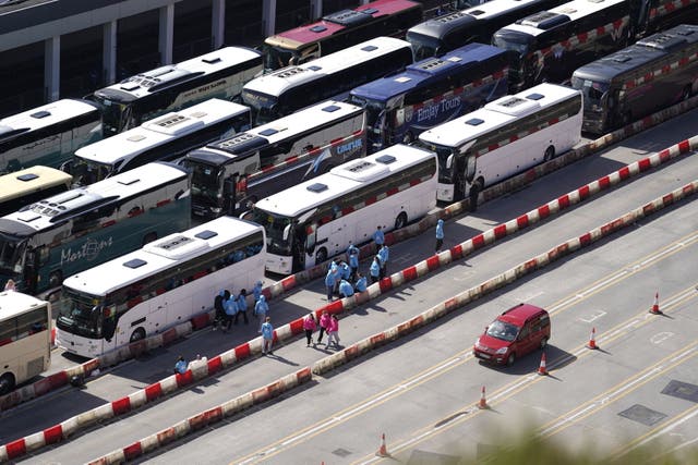 <p>Coaches wait to enter the Port of Dover in Kent after extra sailings were run overnight to try and clear the backlog which has left passengers stuck in Easter traffic for hours</p>