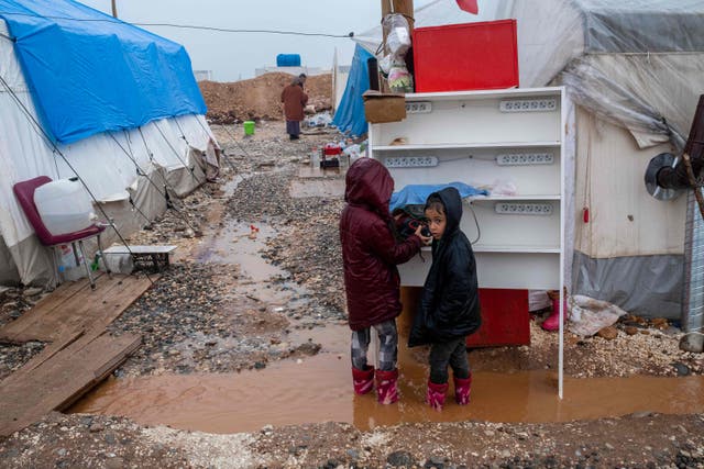 <p>File Children stand under the rain in mud close to their tents, set up to home displaced people following a massive earthquake last month, in Adiyaman, southeastern Turkey</p>