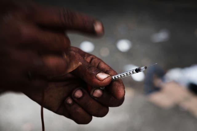 <p>A heroin user displays a needle in a South Bronx neighborhood which has the highest rate of heroin-involved overdose deaths in the city on October 6, 2017 in New York City</p>