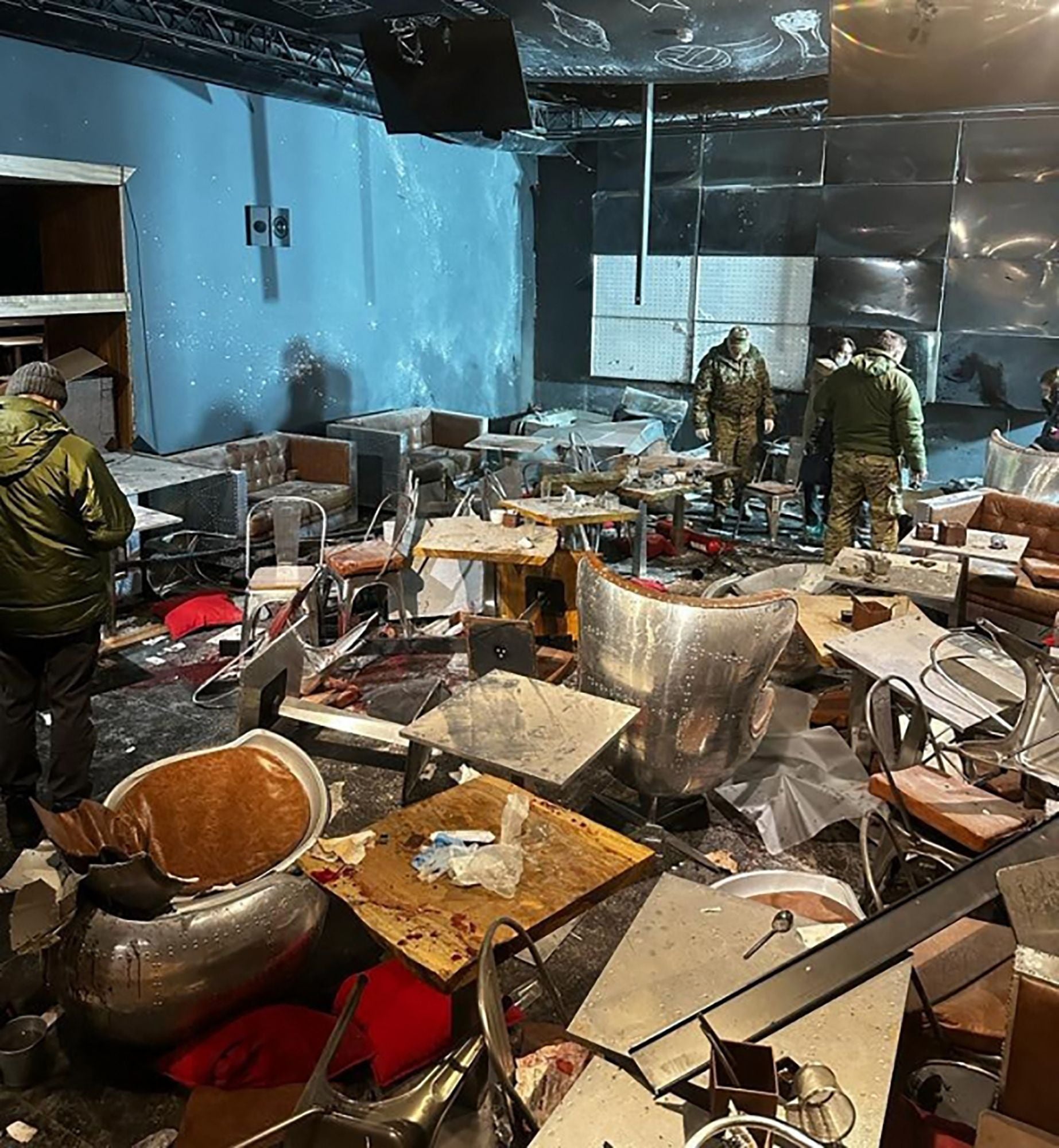 Russian investigators inspect the blasted ‘Street bar’ cafe
