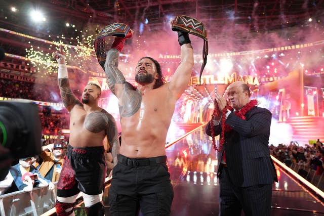 <p>Roman Reigns (centre) is the WWE Universal Champion </p>