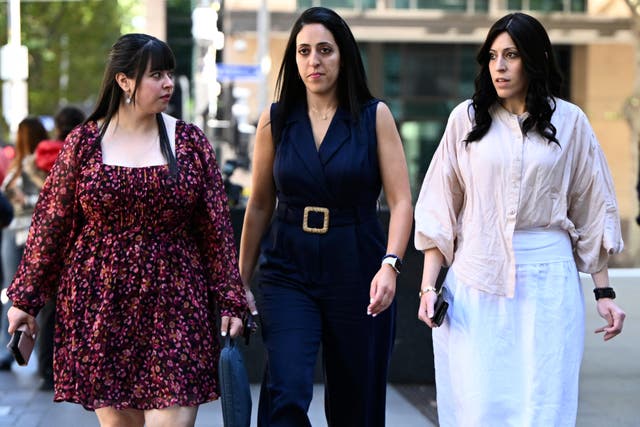 <p>Sisters Dassi Erlich, left, Elly Sapper and Nicole Meyer, right, leave the County Court of Victoria in Melbourne</p>