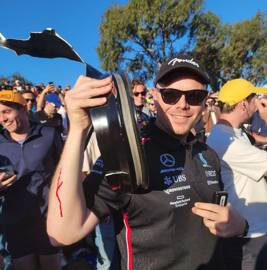 F1 fan Will Sweet poses with the piece of debris which cut his arm at the Australian Grand Prix