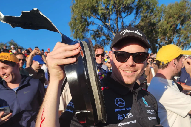 <p>F1 fan Will Sweet poses with the piece of debris which cut his arm at the Australian Grand Prix</p>