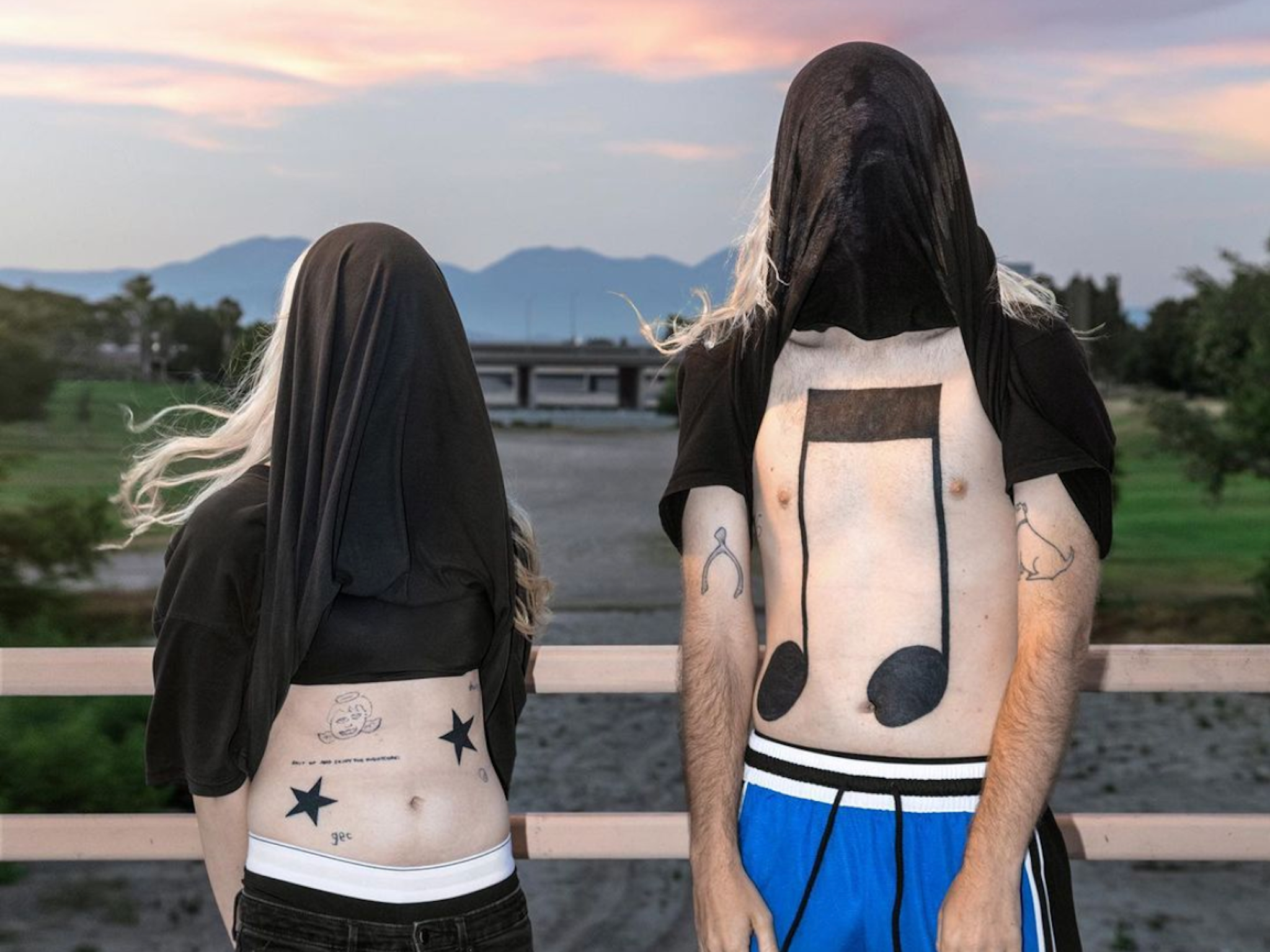 Laura Les and Dylan Brady sport new tattoos on the cover art for ‘10,000 gecs’