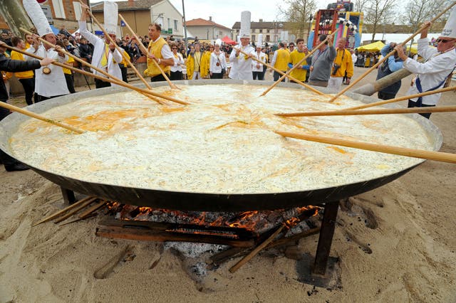 <p>Members of the World Brotherhood of the Knights of the Giant Omelette of Bessières stir their oversize omelette during the city’s annual festival in March 2016</p>