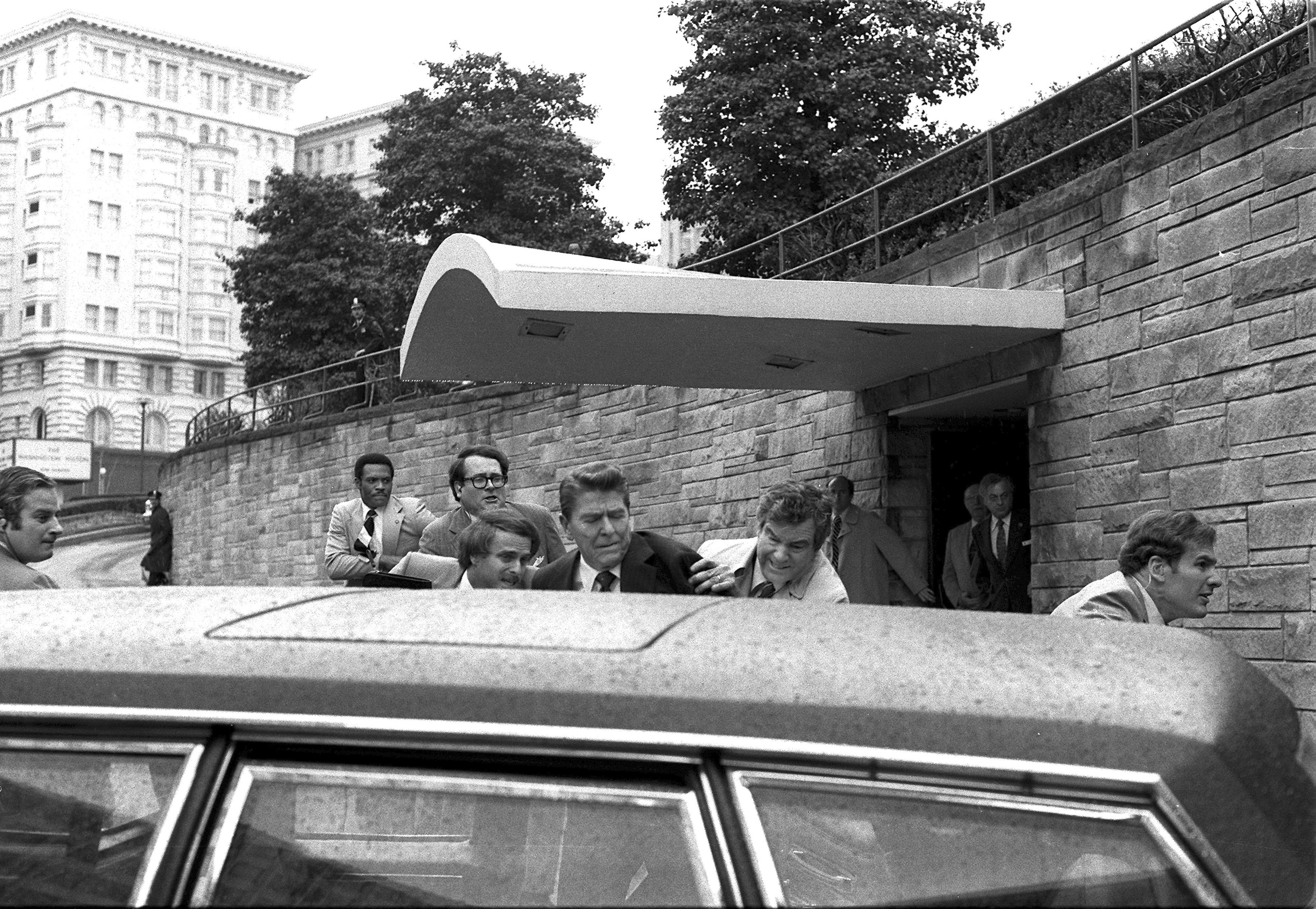 President Ronald Reagan is shoved into the President's limousine by secret service agents after being shot outside a Washington hotel in 1981. John Hinckley Jr, who shot Reagan, has denounced the assassination attempt of Donald Trump