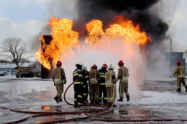 Members of the Slovakian Air Force, (in dark blue), learn how to put out major aircraft fires for the first time in the UK at the RAF Manston Defence Fire Training & Development Centre in Ramsgate, Kent.