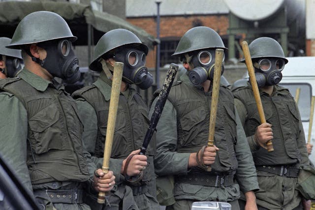 <p>British Army Riot Squad troops wearing gas masks, bullet proof vests and wielding two foot long batons in Belfast </p>