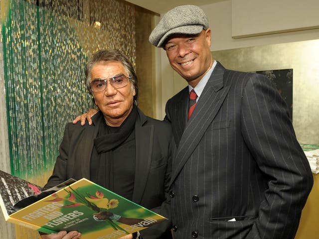 <p>Michael Roberts (right) with Roberto Cavalli in 2009</p>