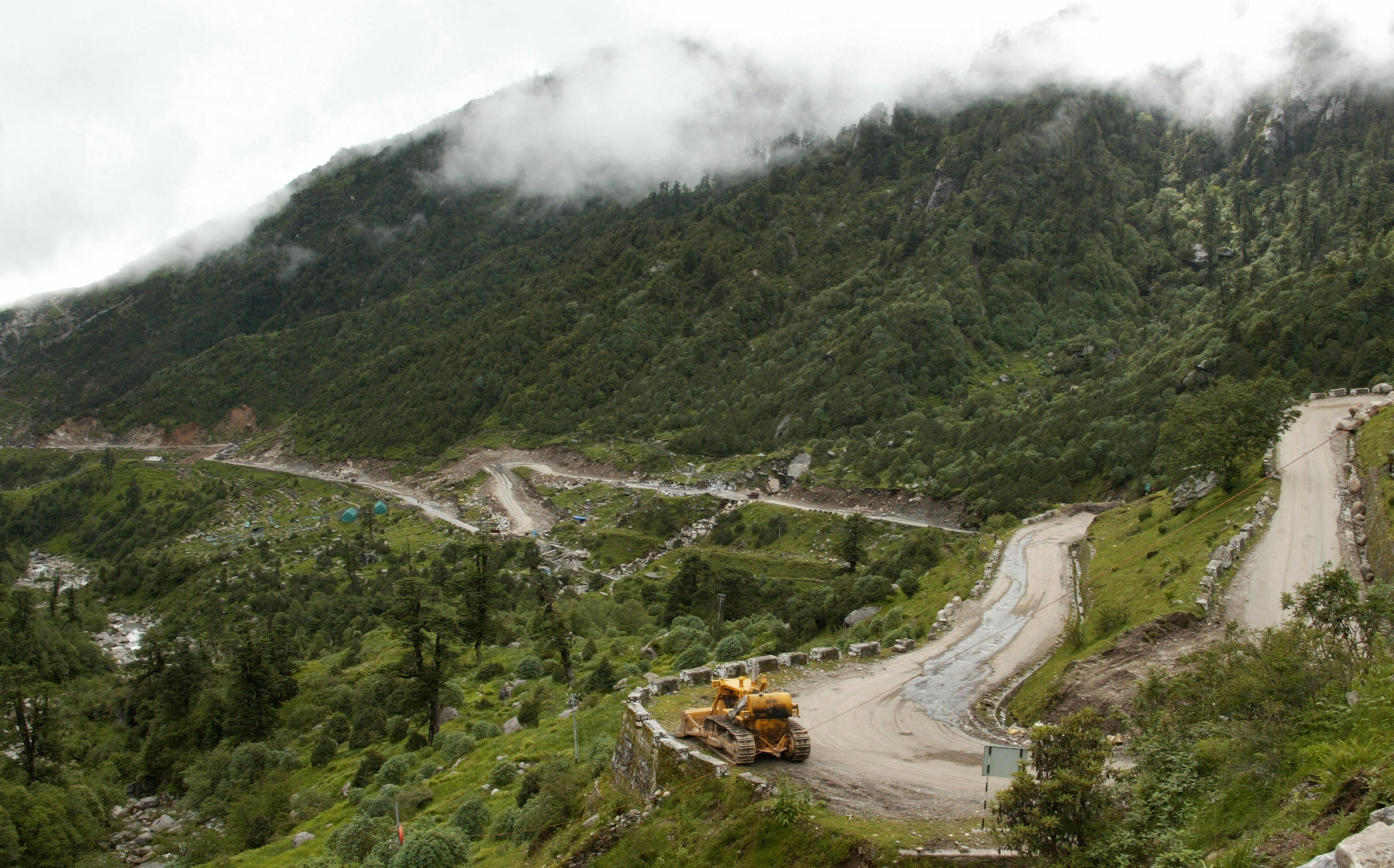 In this file photo taken on 10 July 2008, a bulldozer makes its way along the Nathu La Pass