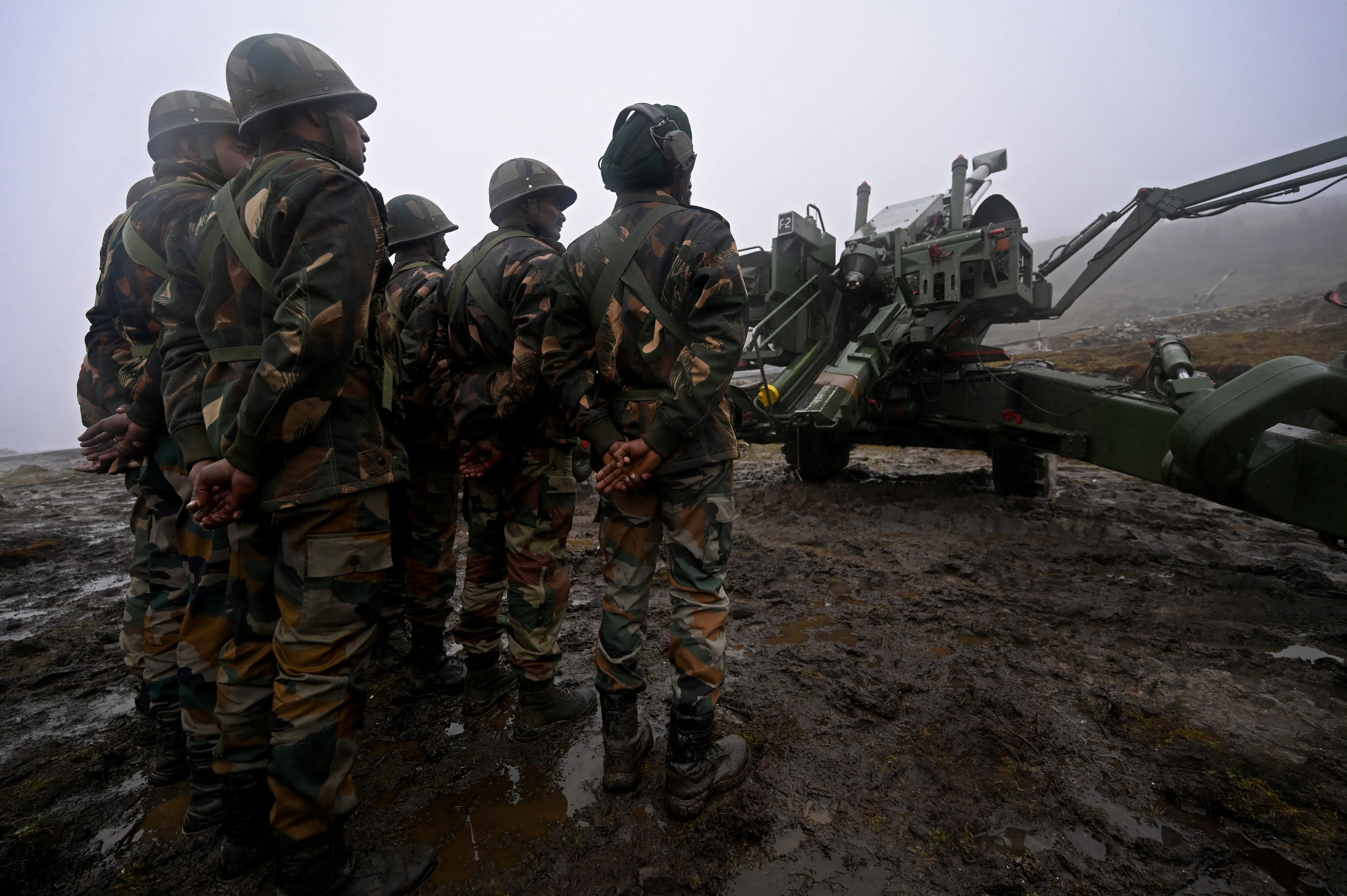 Indian Army soldiers stand next to a Bofors gun positioned at Penga Teng Tso ahead of Tawang