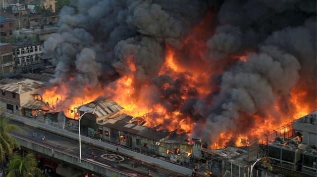 <p>An aerial view shows firefighters trying to douse the blaze at the Bangabazar Market in Dhaka on Tuesday</p>