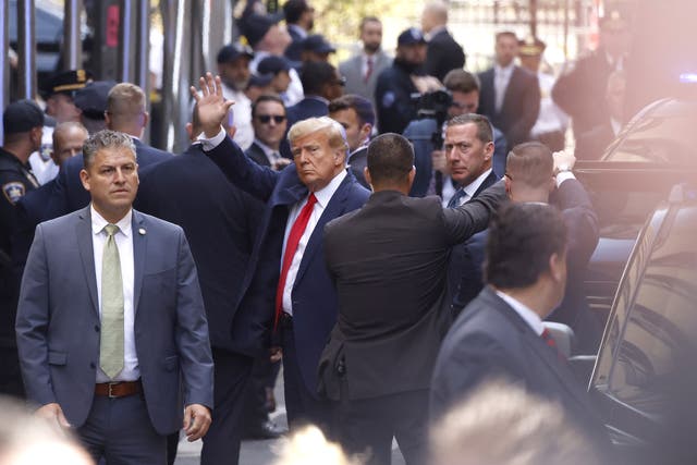 <p>Trump raises his fist as he leaves Trump Tower in Manhattan on Tuesday </p>