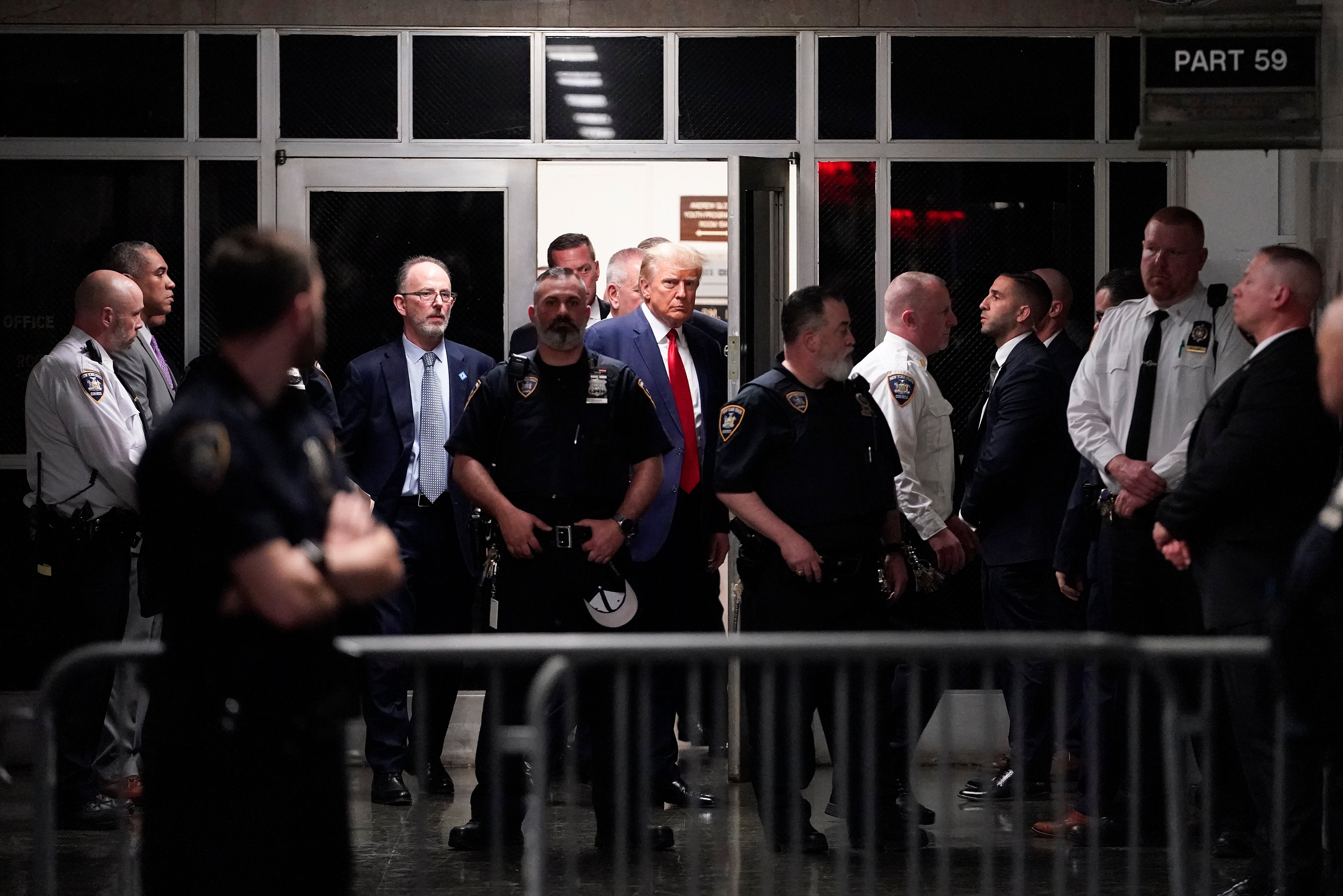 Former President Donald Trump is escorted to a courtroom Tuesday 4 April
