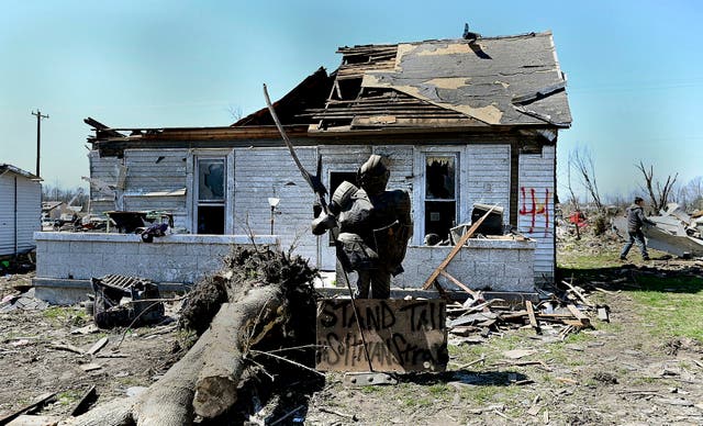 <p>A statue of a knight stands in one of the city's neighborhoods that was damaged by a recent tornado on Monday in Indiana </p>