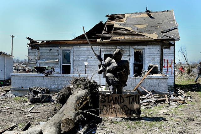 <p>A statue of a knight stands in one of the city's neighborhoods that was damaged by a recent tornado on Monday in Indiana </p>