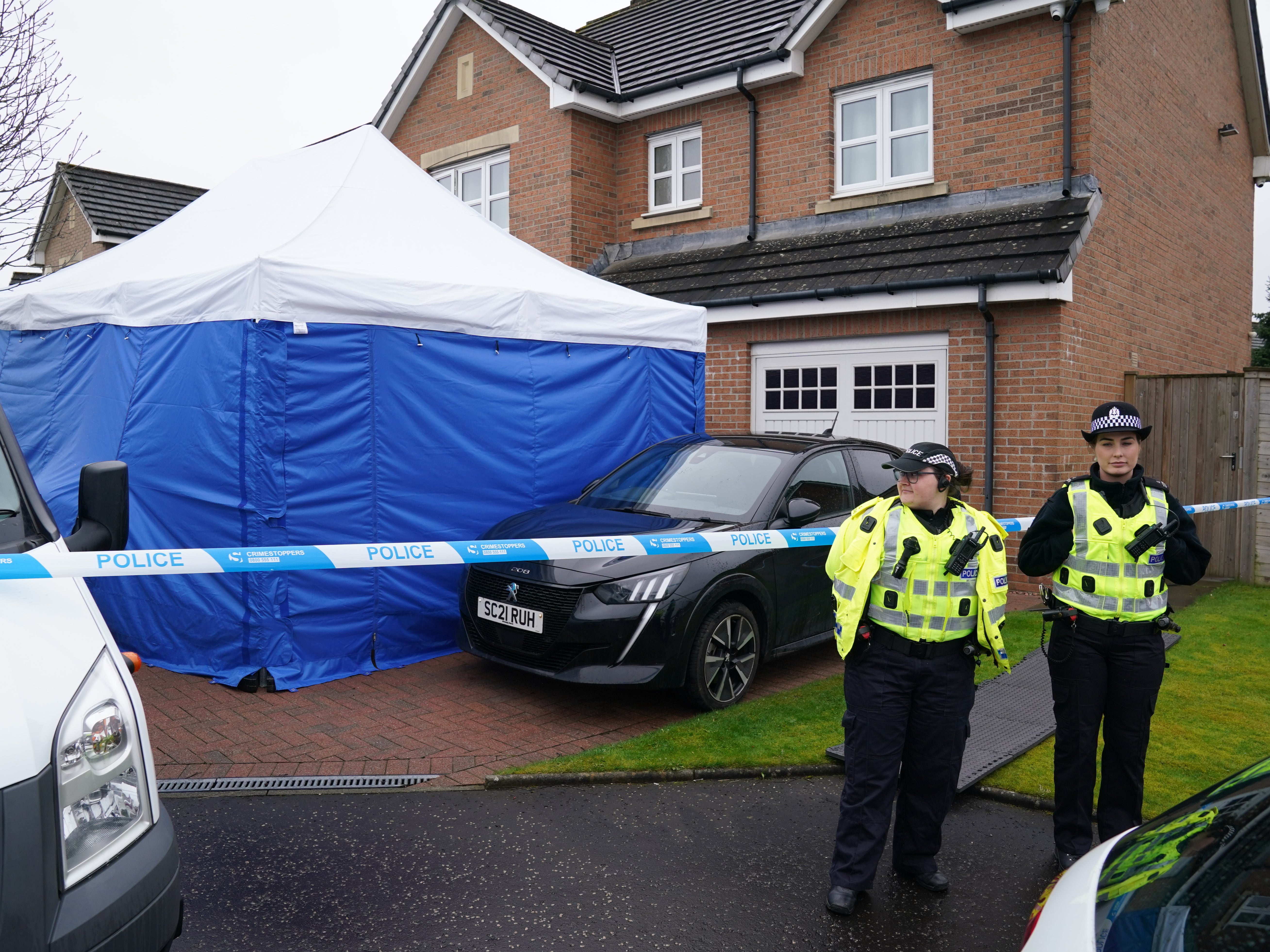 Officers stand beside police tape outside Nicola Sturgeon’s home on Wednesday