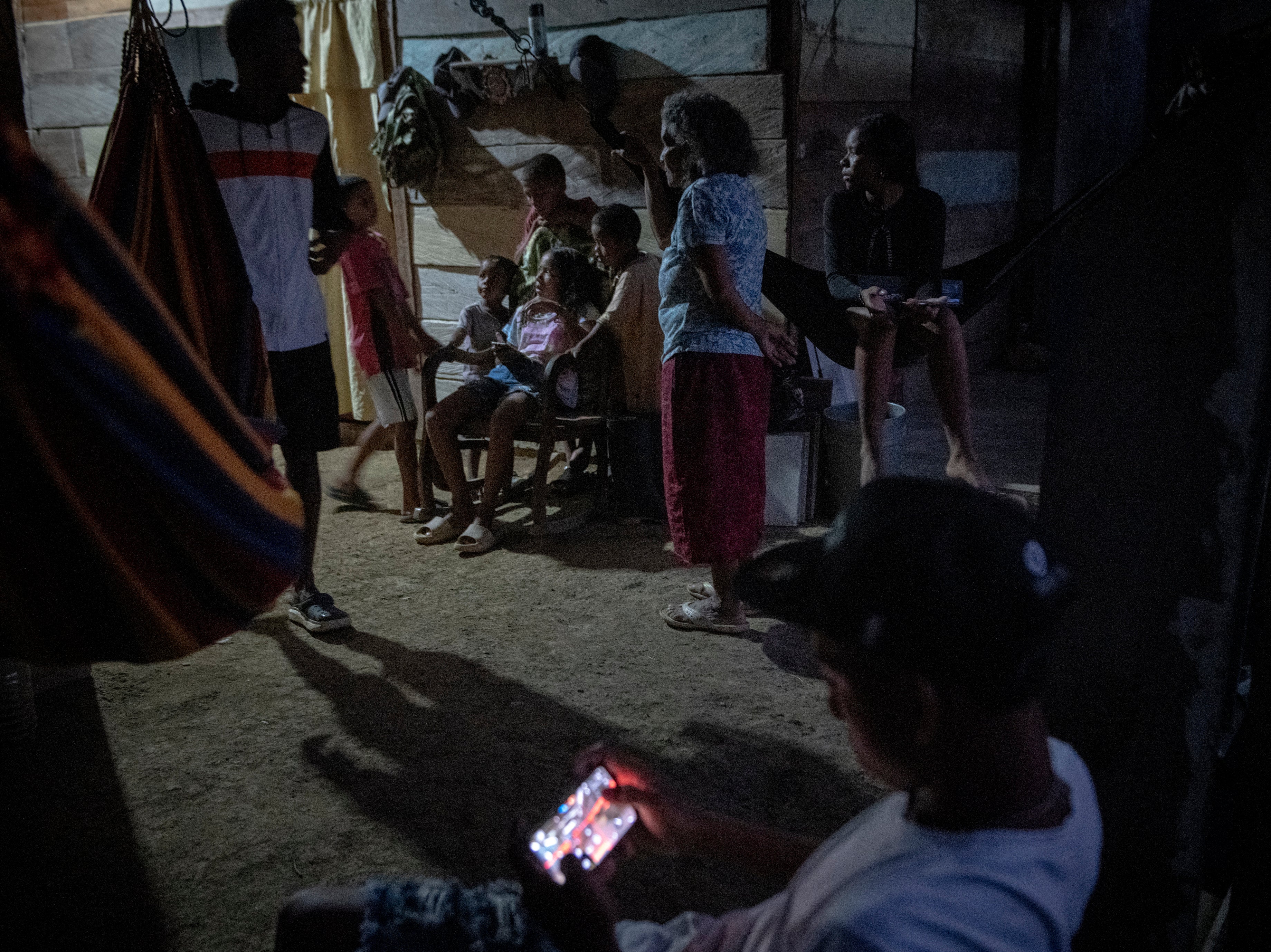 Family members gather in a small home in the northern Chocó region of Colombia