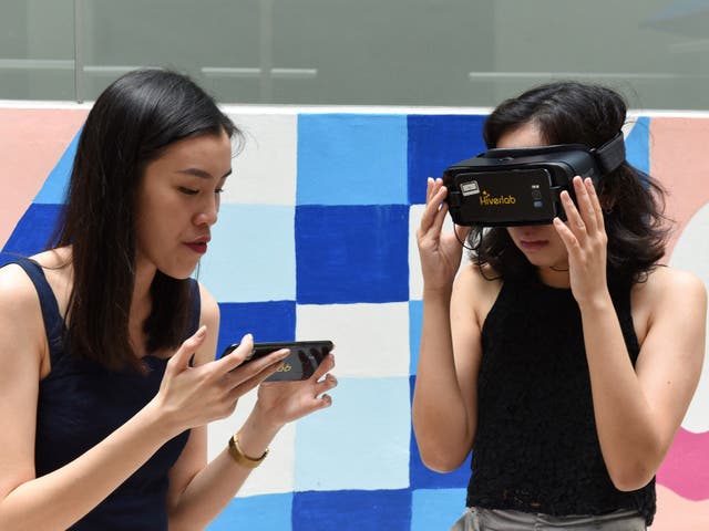 <p>A student is guided through a virtual reality simulation at the Nanyang Technological University in Singapore on 10 March, 2020</p>