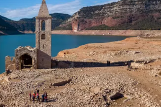 <p>The remains of a church and ancient village emerged from the drought-stricken Sau reservoir in Vilanova de Sau, Catalonia</p>