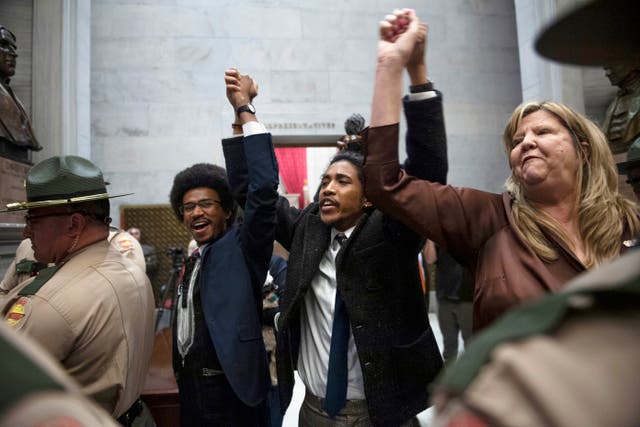 <p>From left, Tennessee state Rep. Justin Pearson, state Rep. Justin Jones and state Rep. Gloria Johnson hold their hands up as they exit the House Chamber doors at Tennessee state Capitol Building in Nashville, Tenn., Monday, April 3, 2023</p>