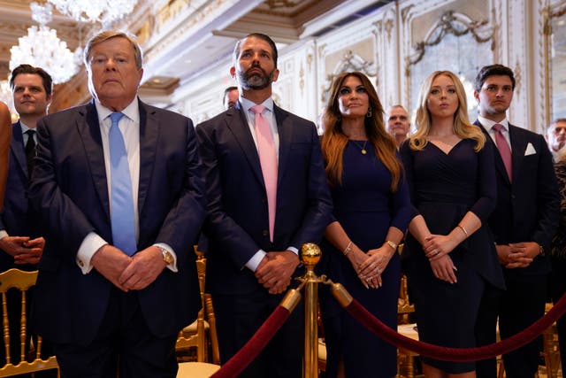 <p>Donald Trump Jr (second left) listens to his father’s post-arraignment speech at Mar-a-Lago on Tuesday </p>