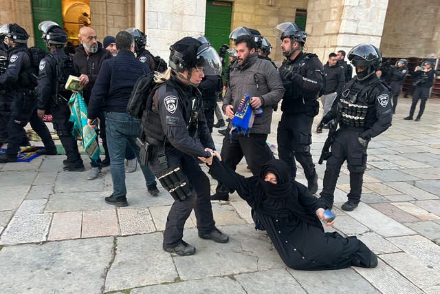 <p>Israeli forces remove Palestinian Muslim worshippers from the al-Aqsa mosque compound in Jerusalem on Wednesday after the earlier clashes</p>