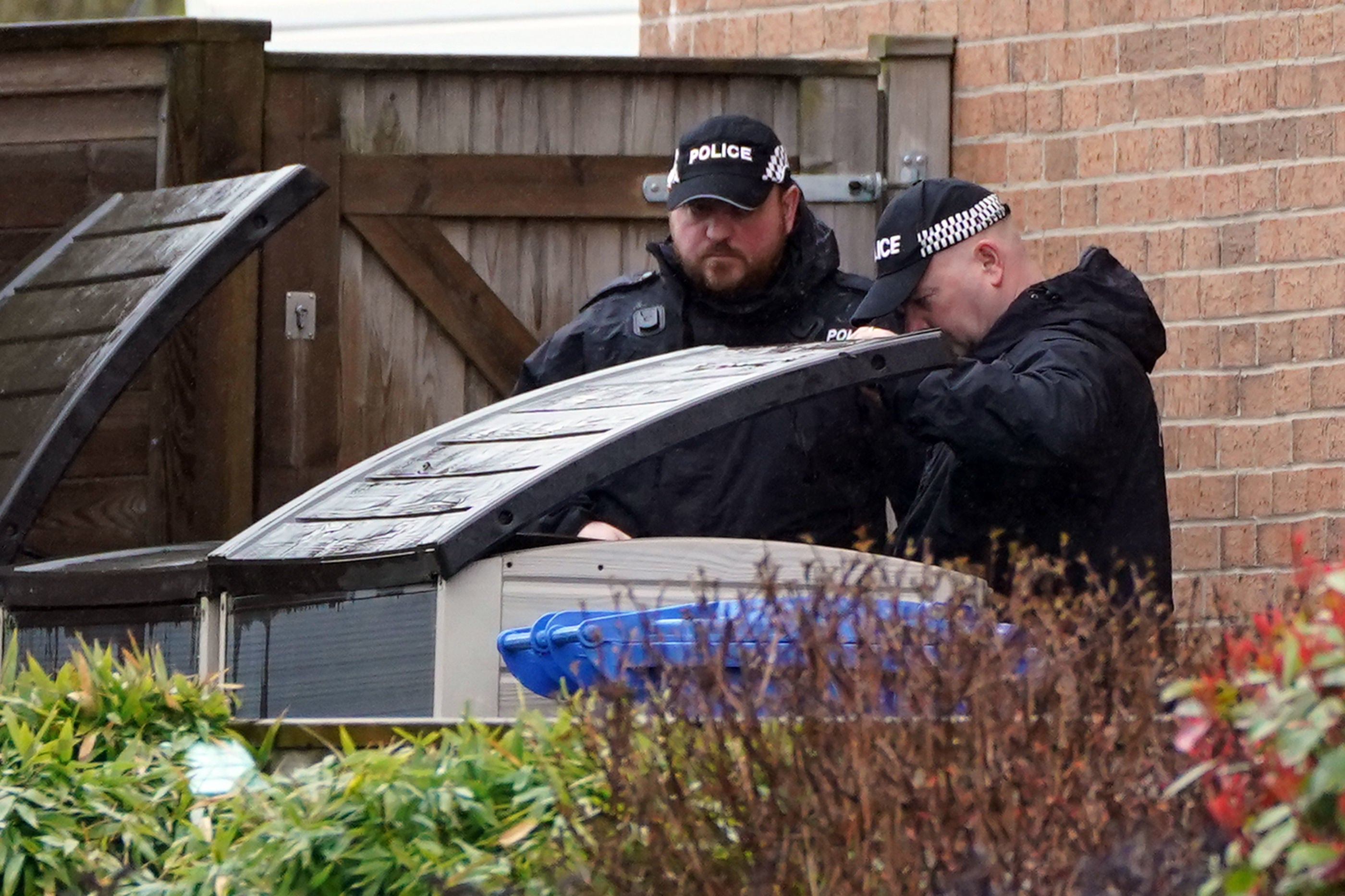 Officers from Police Scotland were seen looking through bins outside the home