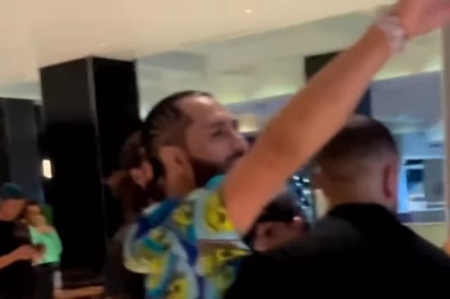 <p>Jorge Masvidal is held back by security while talking to Kevin Holland</p>