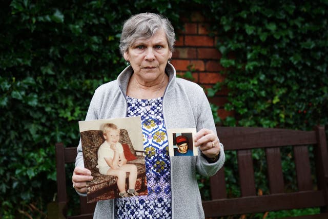 Linda Molloy holds photographs of her son John (Brian Lawless/PA)