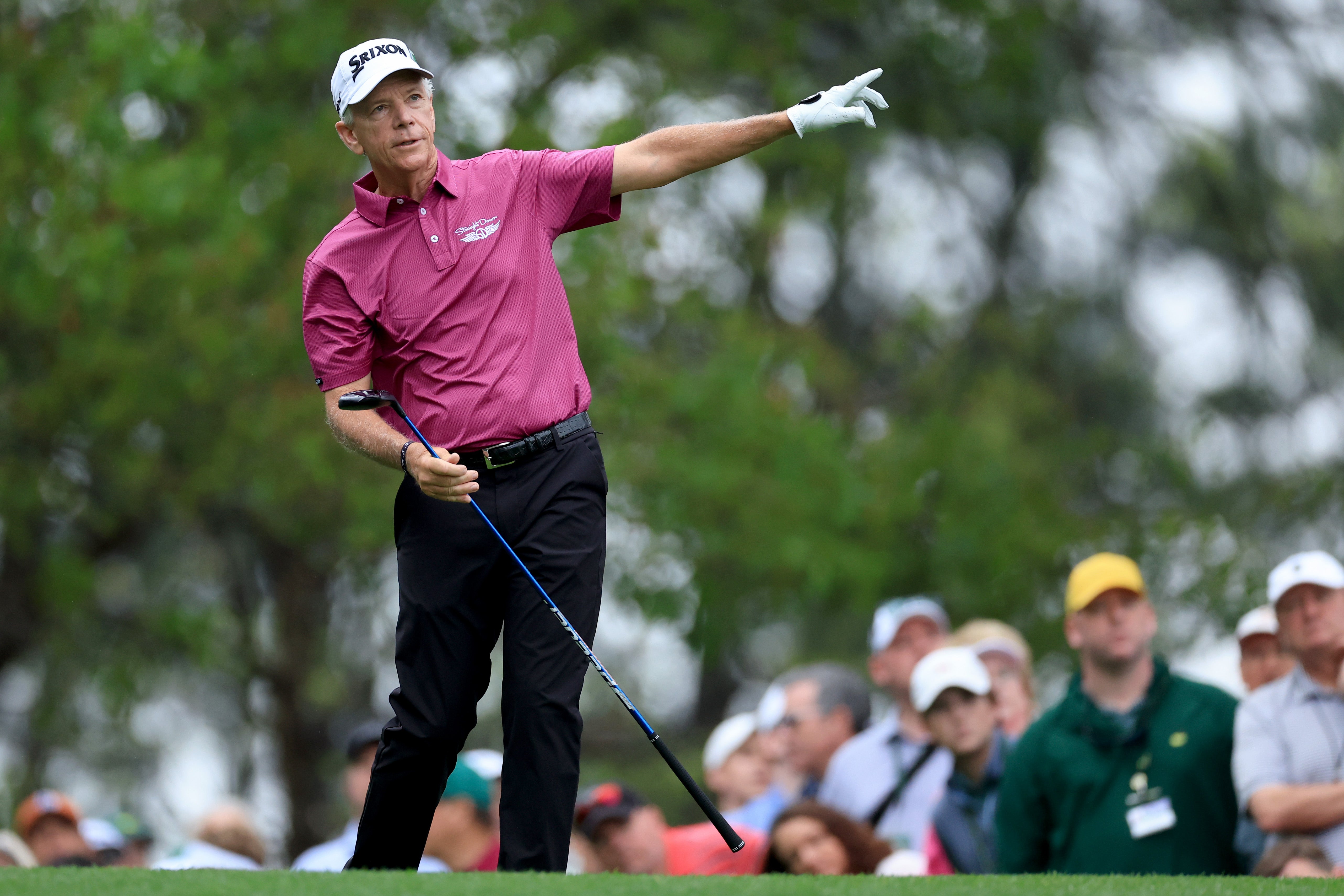 Larry Mize signals after a shot off the fourth tee at Augusta National