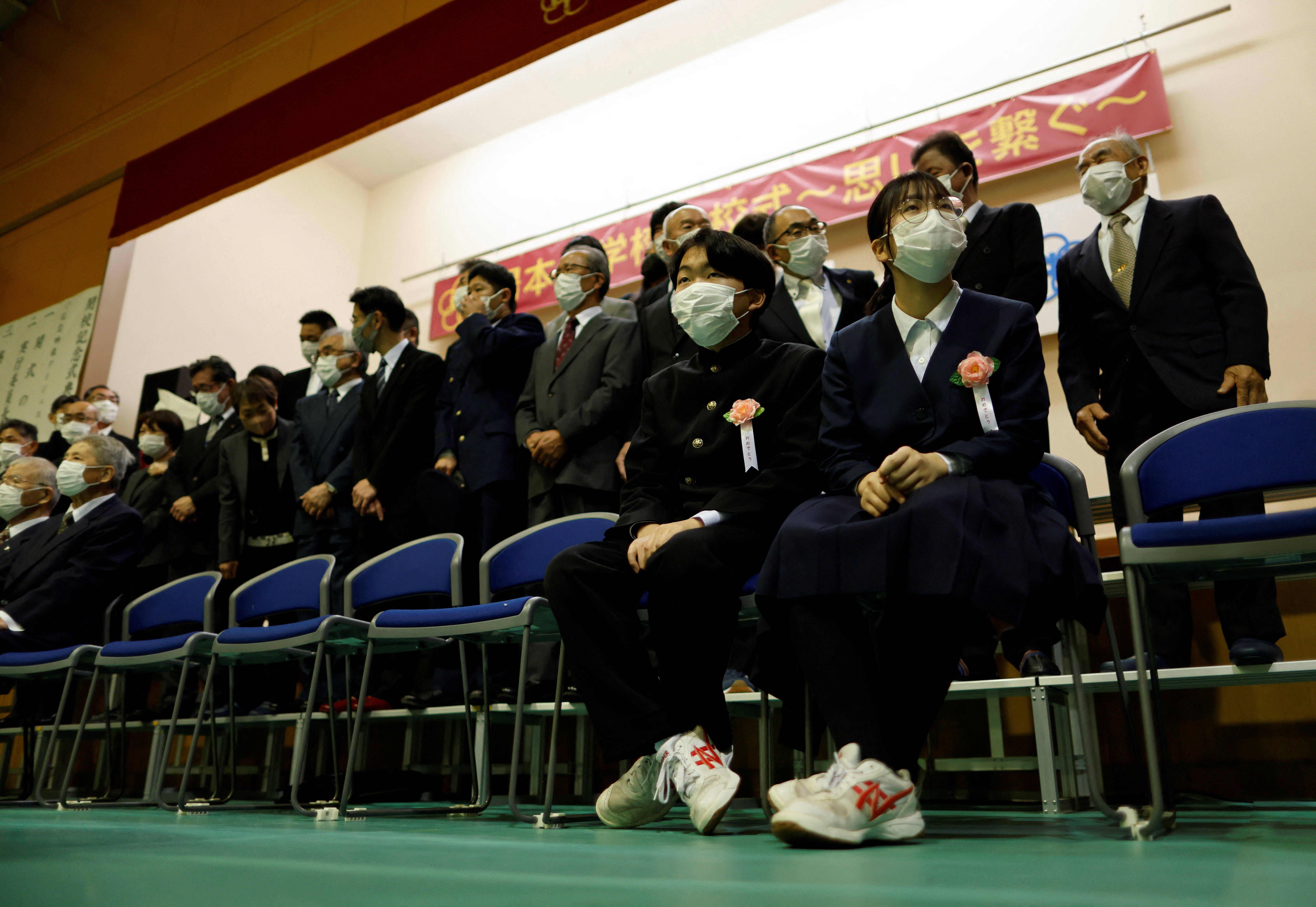 The duo attend a photo session with guests for the school’s closing ceremony