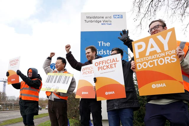 Striking NHS junior doctors on a picket line (PA)