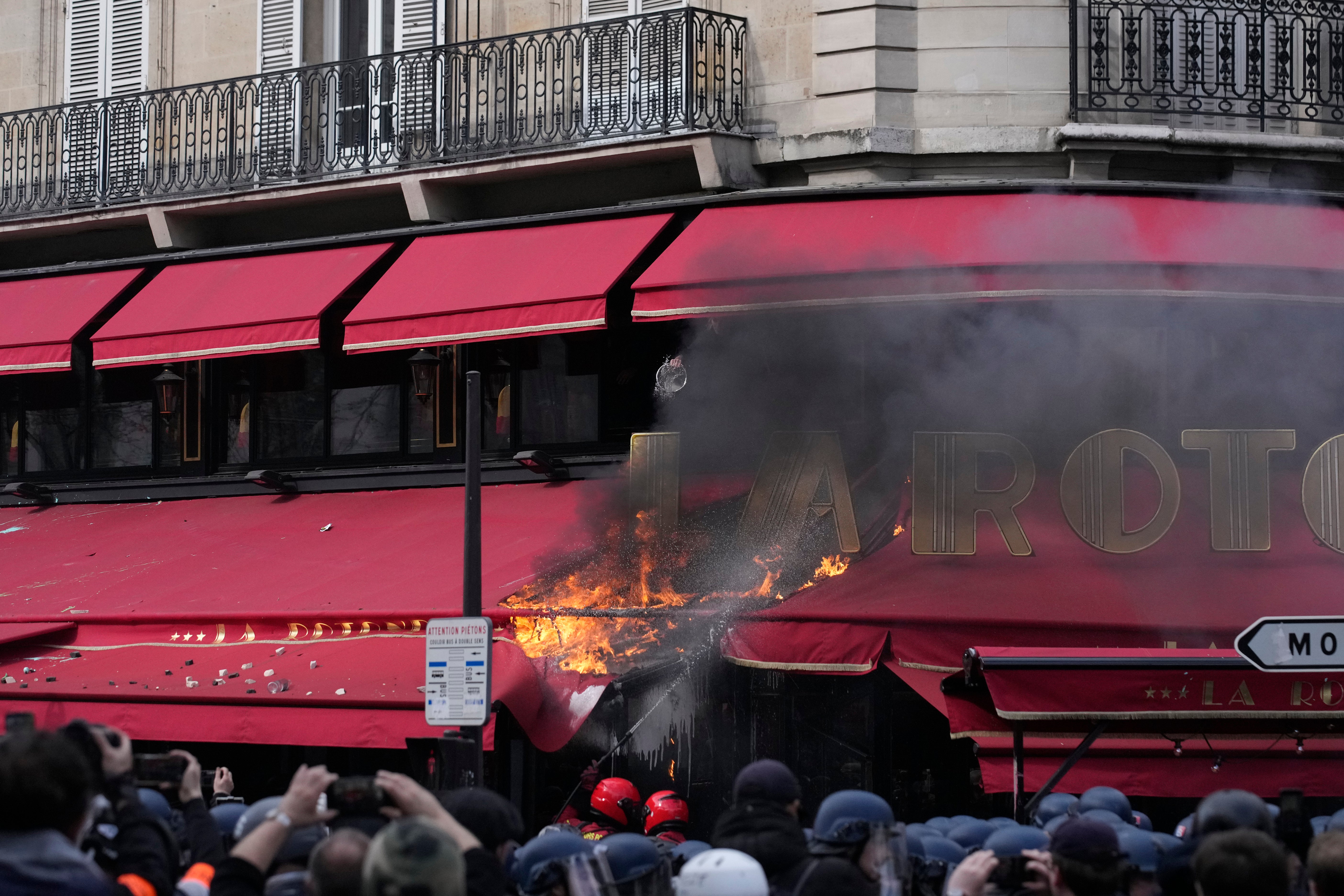 A restaurant awning burns in Paris on the latest day of strikes and protests