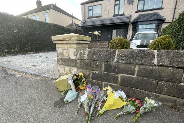 Floral tributes left outside a house on Hemper Lane, Greenhill, Sheffield (Dave Higgens/PA)