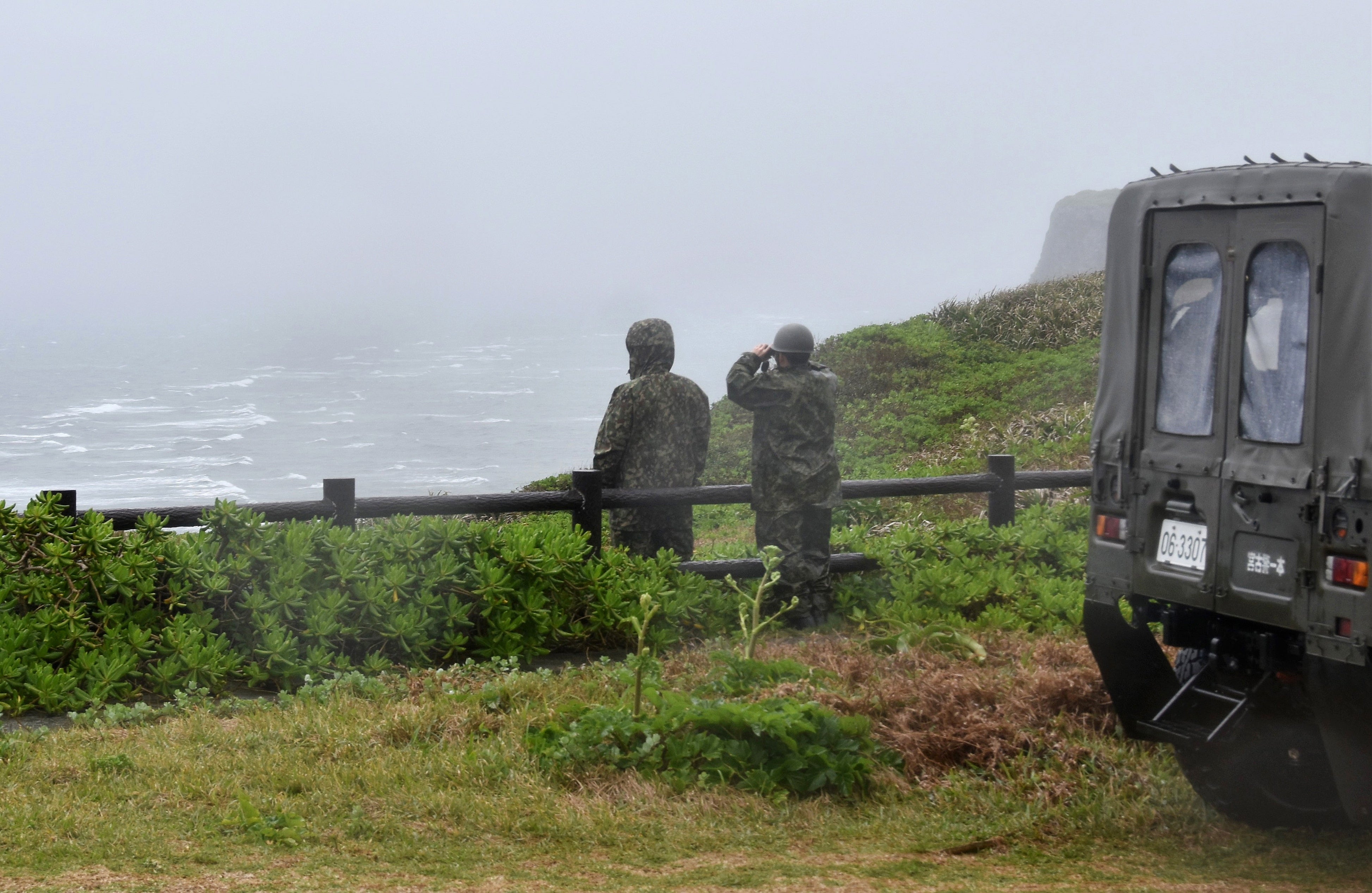 Japan’s Ground Self-Defence Force personnel look out from the northern top of Irabu Island