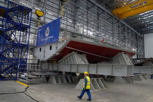 A worker passing the Keel before the Keel Laying Ceremony for the first Type 31 Frigate, at Babcock Rosyth in Rosyth (Andrew Milligan/PA)
