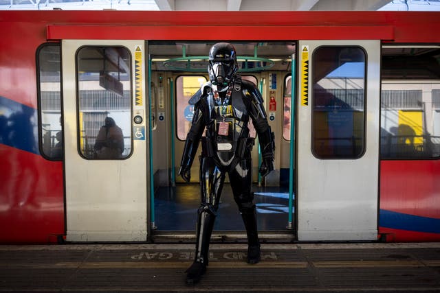 <p>A Star Wars fan dressed as an Imperial Death Trooper arrives at ExCeL convention centre to attend Star Wars Celebration event in London</p>
