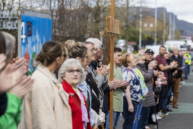 People applaud after taking part in Worship Between the Gates, part of the Human peace wall in Belfast (Liam McBurney/PA)